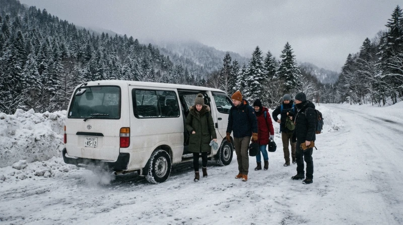 Small tour van on a snowy road above Lake Toya on a small-group Noboribetsu day trip from Sapporo near Noboribetsu Bear Park, Hokkaido